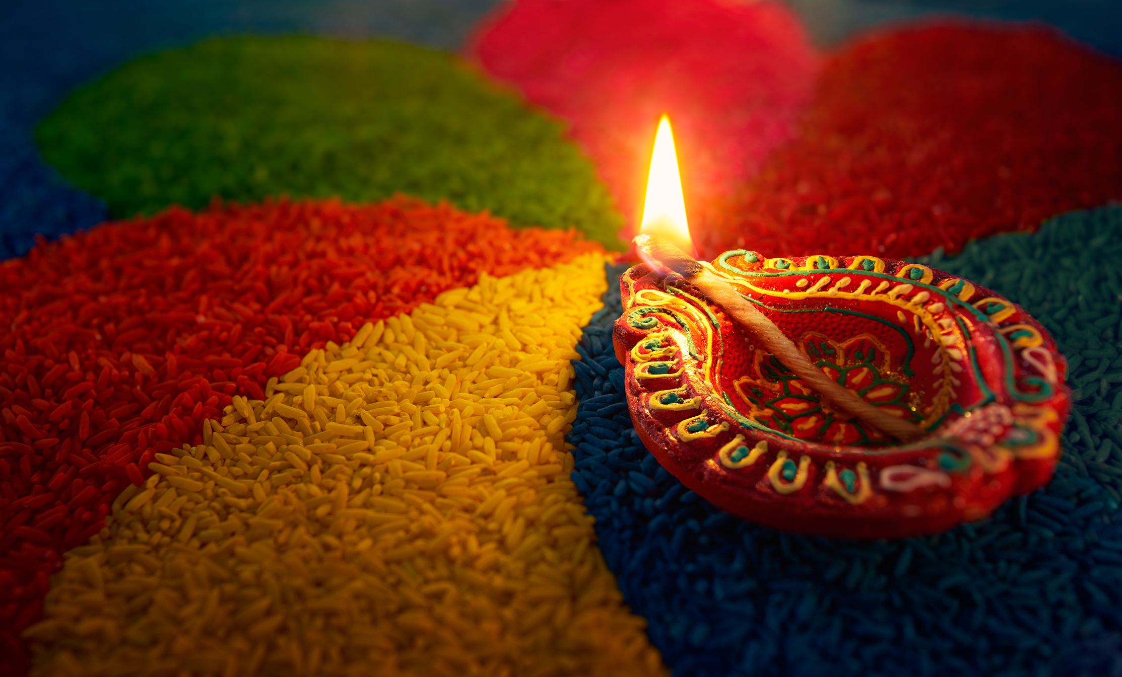 Lampe à huile Diwali - Lampe Diya allumée sur rangoli coloré
